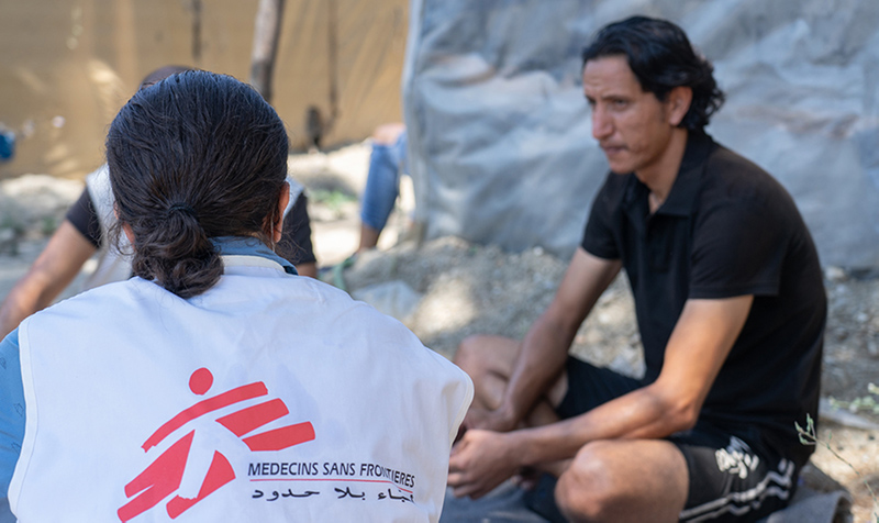 MSF staff speaks with a man from Syria in Vathy refugee camp in Samos.