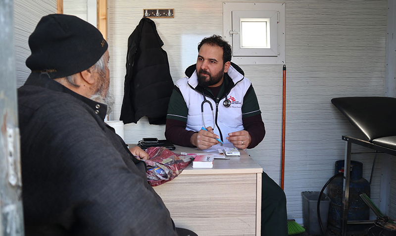 A displaced Syrian man talking with a doctor during a consultation at the MSF mobile clinic,Northwest Syria.